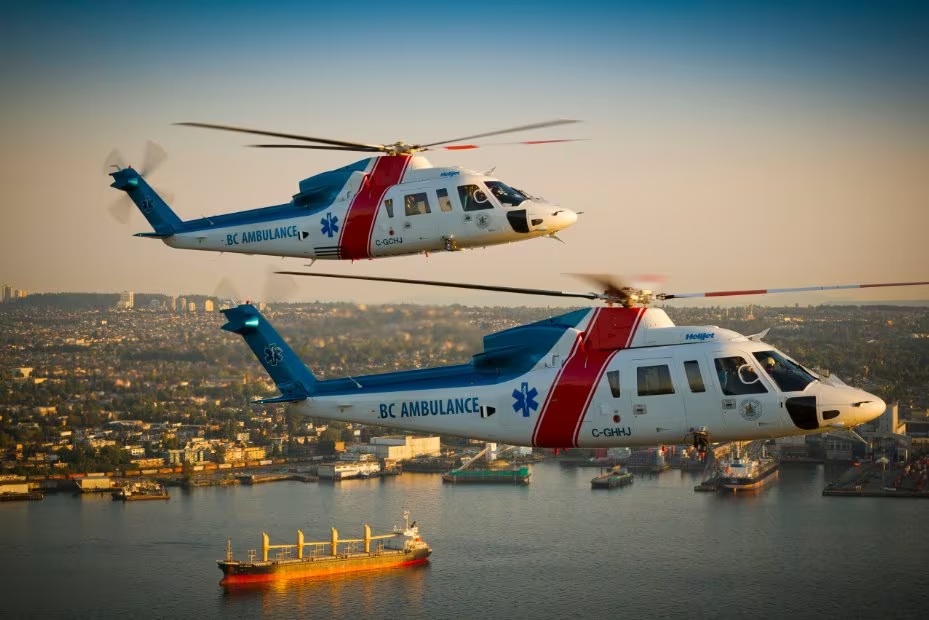 An image of two helicopters flying together over Victoria harbor